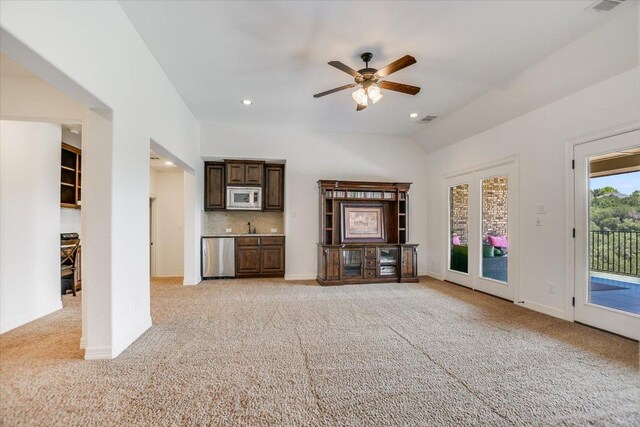 1016 Santaluz Path, Austin, TX 78732 - unfurnished living room with light carpet, a ceiling fan, lofted ceiling, recessed lighting, and bar with sink