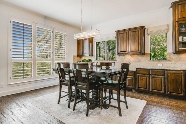 1016 Santaluz Path, Austin, TX 78732 - dining space featuring ornamental molding, a chandelier, and dark wood-style flooring