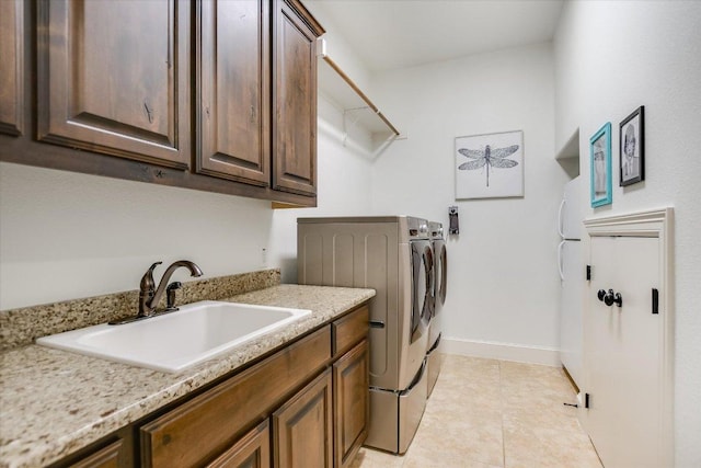 1016 Santaluz Path, Austin, TX 78732 - laundry room with independent washer and dryer, cabinet space, and light tile patterned floors