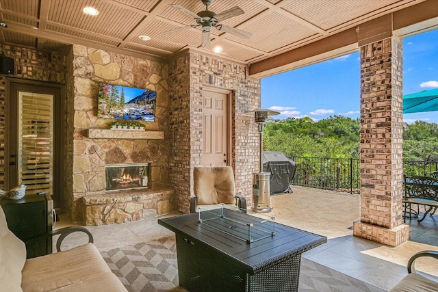 1016 Santaluz Path, Austin, TX 78732 - view of patio / terrace with an outdoor stone fireplace, grilling area, and a ceiling fan