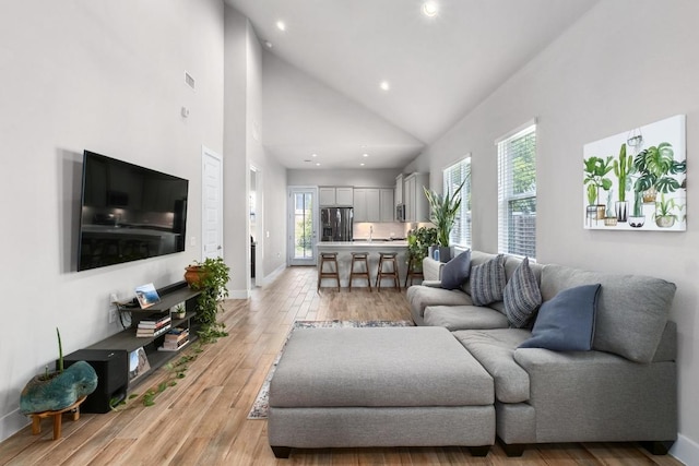 213 Virtus Bnd Unit 25, Austin, TX 78748 - living room featuring light wood-style floors, recessed lighting, high vaulted ceiling, and baseboards
