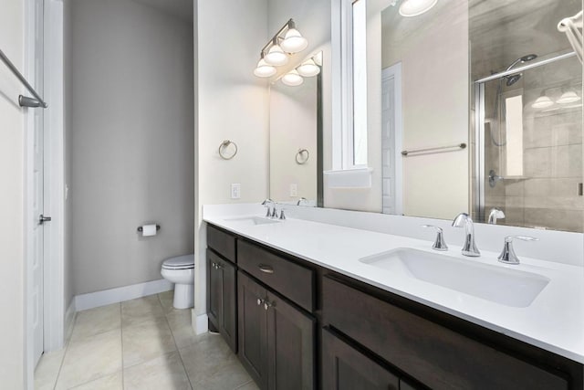 213 Virtus Bnd Unit 25, Austin, TX 78748 - full bath with double vanity, toilet, a stall shower, tile patterned floors, and baseboards