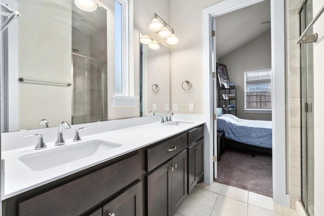 213 Virtus Bnd Unit 25, Austin, TX 78748 - bathroom featuring lofted ceiling, tile patterned floors, ensuite bath, a shower stall, and double vanity