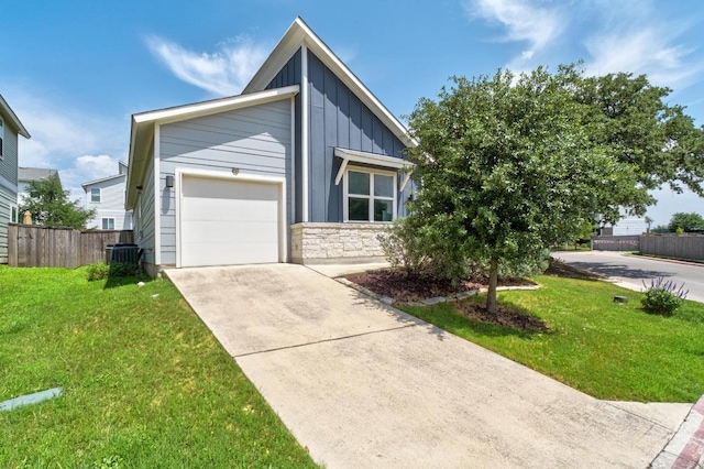 213 Virtus Bnd Unit 25, Austin, TX 78748 - mid-century home featuring board and batten siding, concrete driveway, an attached garage, central air condition unit, and stone siding