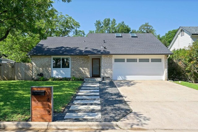 3415 Clarksburg Dr, Austin, TX 78745 - view of front of home featuring an attached garage, driveway, roof with shingles, and stone siding