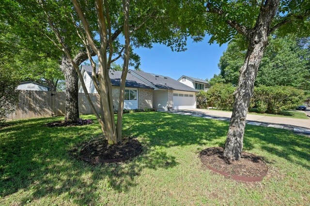 3415 Clarksburg Dr, Austin, TX 78745 - view of front of property featuring an attached garage and driveway