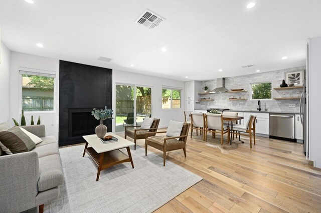 3415 Clarksburg Dr, Austin, TX 78745 - living area with plenty of natural light, light wood-style flooring, recessed lighting, and a large fireplace