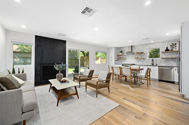 3415 Clarksburg Dr, Austin, TX 78745 - living room with plenty of natural light, light wood-type flooring, recessed lighting, and a fireplace
