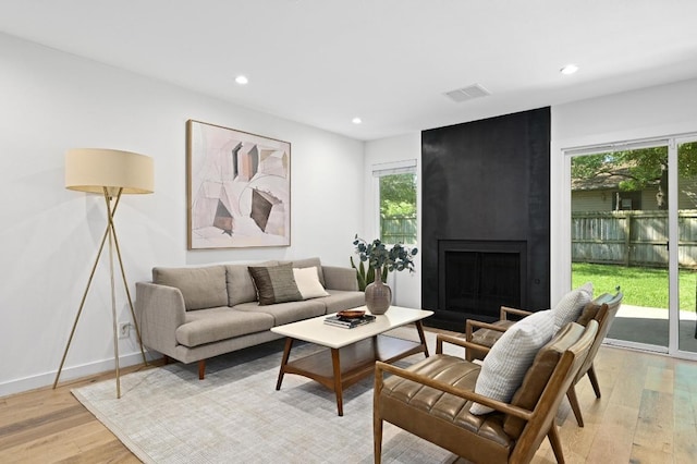 3415 Clarksburg Dr, Austin, TX 78745 - living area with recessed lighting, light wood finished floors, and a fireplace
