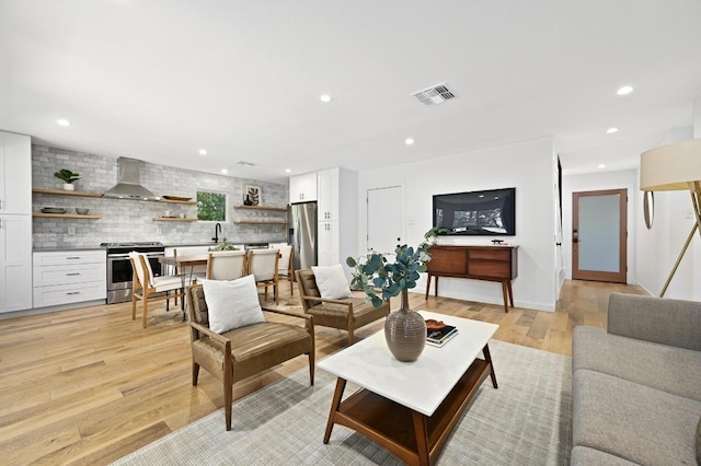 3415 Clarksburg Dr, Austin, TX 78745 - living area featuring light wood finished floors and recessed lighting