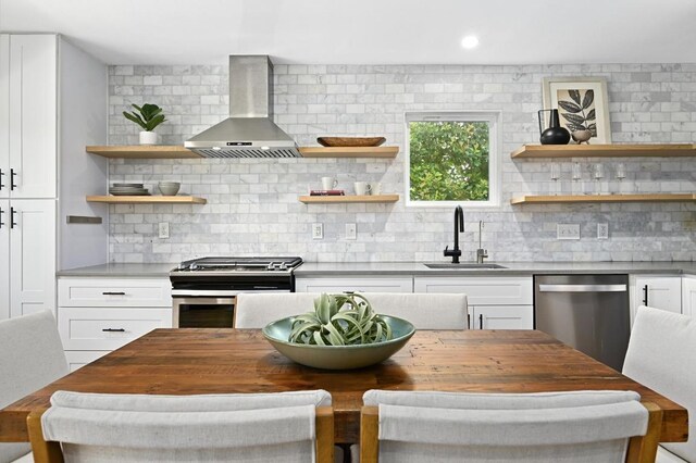 3415 Clarksburg Dr, Austin, TX 78745 - kitchen with wall chimney exhaust hood, a sink, stainless steel appliances, open shelves, and backsplash