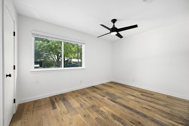 3415 Clarksburg Dr, Austin, TX 78745 - empty room with wood finished floors, ceiling fan, and baseboards