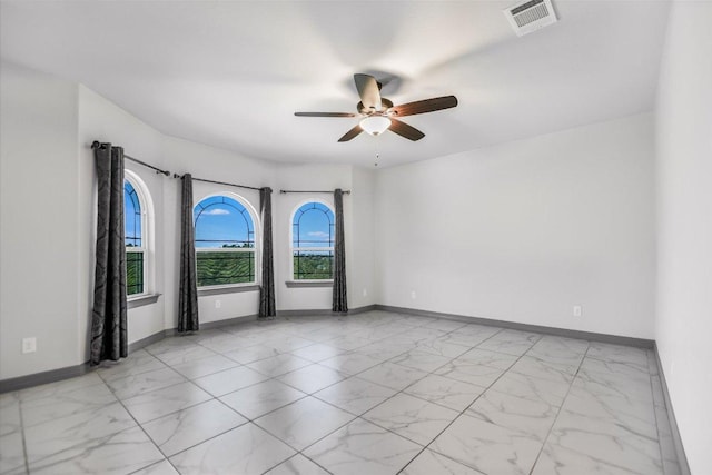 427 Bella Montagna Cir, Austin, TX 78734 - unfurnished room with light marble finish floors, ceiling fan, and baseboards