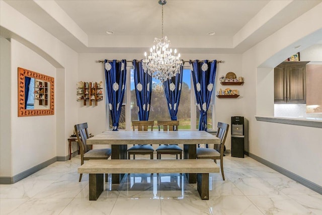 427 Bella Montagna Cir, Austin, TX 78734 - dining room featuring a tray ceiling, baseboards, a chandelier, and light marble finish flooring