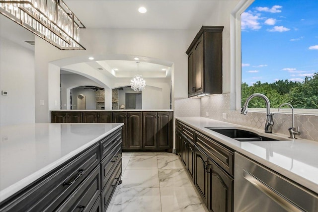 427 Bella Montagna Cir, Austin, TX 78734 - kitchen with stainless steel dishwasher, a sink, a chandelier, recessed lighting, and arched walkways