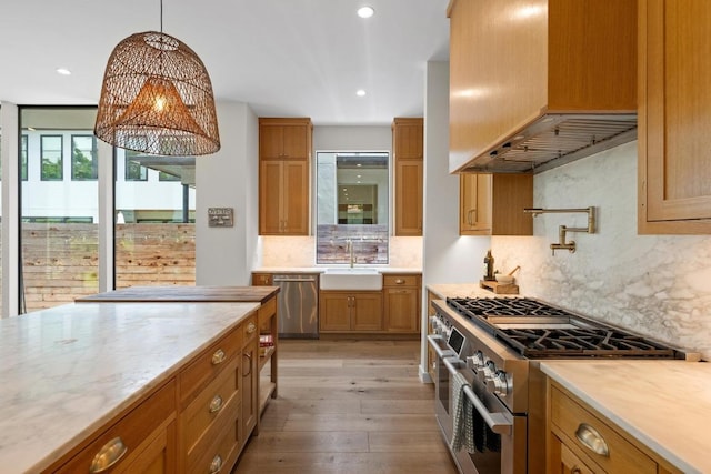 2024 Ford St, Austin, TX 78704 - kitchen with stainless steel appliances, custom exhaust hood, a sink, tasteful backsplash, and light wood-type flooring