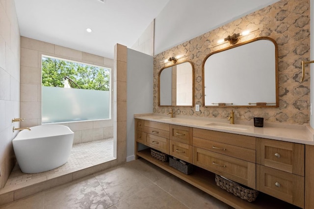 2024 Ford St, Austin, TX 78704 - full bathroom featuring double vanity, a freestanding bath, tile patterned floors, and backsplash