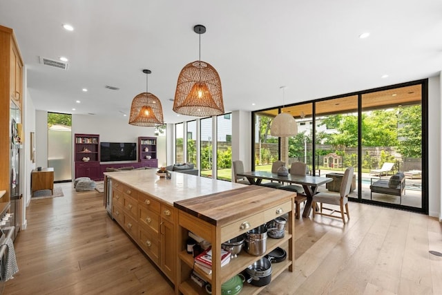 2024 Ford St, Austin, TX 78704 - kitchen with a wall of windows, light wood finished floors, open shelves, decorative light fixtures, and recessed lighting
