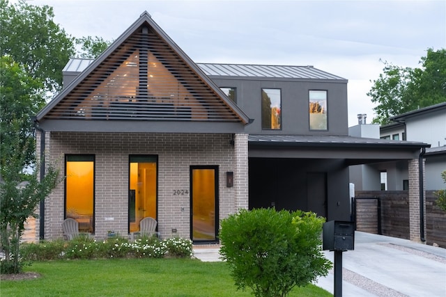 2024 Ford St, Austin, TX 78704 - view of front of property featuring a standing seam roof, brick siding, a front lawn, and metal roof