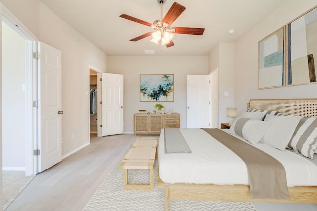 11117 Old Quarry Rd, Austin, TX 78717 - bedroom featuring light wood finished floors, a ceiling fan, baseboards, and a spacious closet