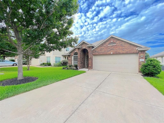 11117 Old Quarry Rd, Austin, TX 78717 - view of front facade with brick siding, driveway, an attached garage, and a front lawn