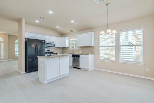 11117 Old Quarry Rd, Austin, TX 78717 - kitchen with stainless steel appliances, a chandelier, decorative backsplash, white cabinetry, and a center island