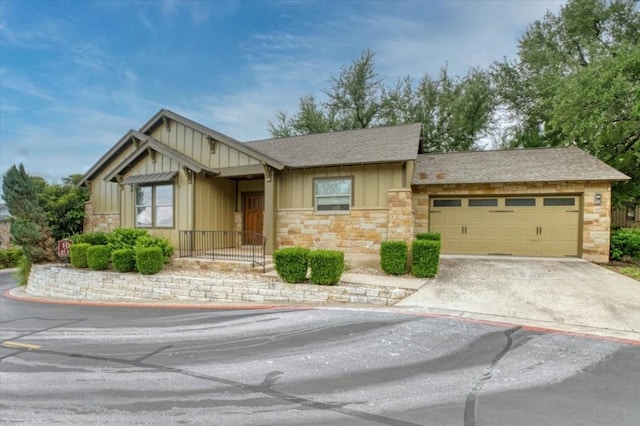 14501 Falcon Head Blvd Unit 43, Austin, TX 78738 - view of front of house with board and batten siding, stone siding, a garage, and a shingled roof
