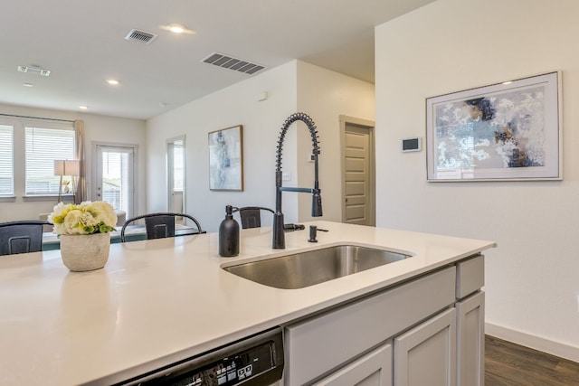 98 Barton Creek Ln, Hutto, TX 78634 - kitchen featuring light countertops, dark wood-style flooring, dishwasher, recessed lighting, and open floor plan