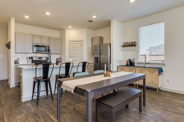 98 Barton Creek Ln, Hutto, TX 78634 - dining room with dark wood finished floors, recessed lighting, and radiator heating unit
