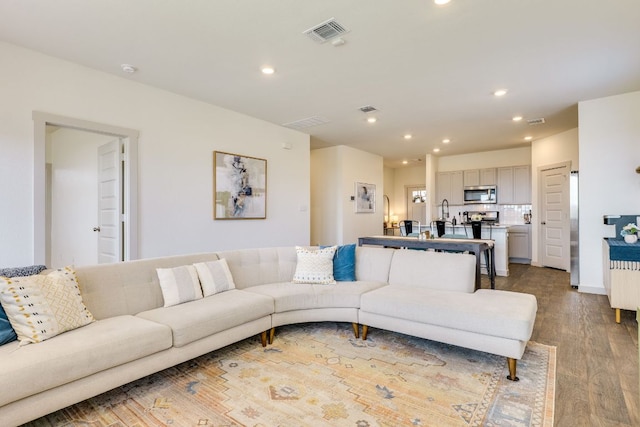 98 Barton Creek Ln, Hutto, TX 78634 - living room featuring wood finished floors and recessed lighting