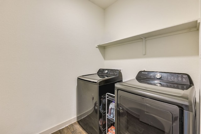 98 Barton Creek Ln, Hutto, TX 78634 - laundry area with washer and dryer, dark wood-type flooring, and baseboards