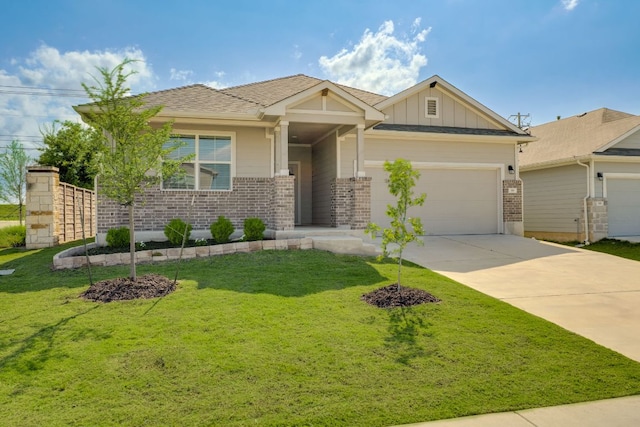 98 Barton Creek Ln, Hutto, TX 78634 - view of front of property with brick siding, board and batten siding, an attached garage, concrete driveway, and a front lawn