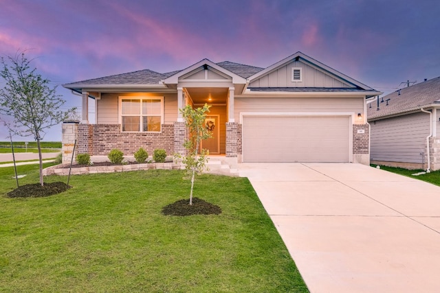 98 Barton Creek Ln, Hutto, TX 78634 - craftsman-style house with a garage, a front lawn, driveway, brick siding, and board and batten siding