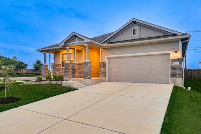 98 Barton Creek Ln, Hutto, TX 78634 - craftsman-style home with board and batten siding, covered porch, concrete driveway, brick siding, and an attached garage