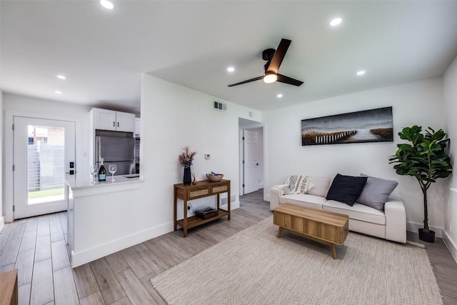 1200 E 52nd St Unit 105, Austin, TX 78723 - living room with light wood finished floors, recessed lighting, ceiling fan, and baseboards