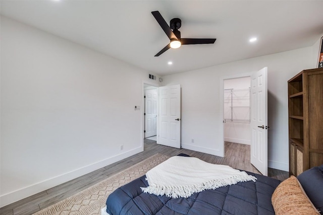 1200 E 52nd St Unit 105, Austin, TX 78723 - bedroom with baseboards, wood finished floors, recessed lighting, a ceiling fan, and a spacious closet