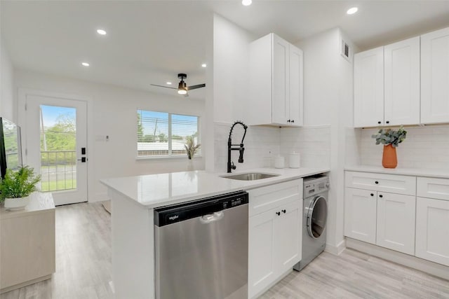 1200 E 52nd St Unit 105, Austin, TX 78723 - kitchen with stainless steel dishwasher, a sink, washer / dryer, light wood-style flooring, and recessed lighting