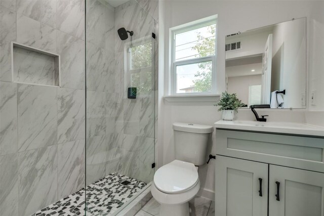 1200 E 52nd St Unit 105, Austin, TX 78723 - bathroom featuring toilet, vanity, and tiled shower