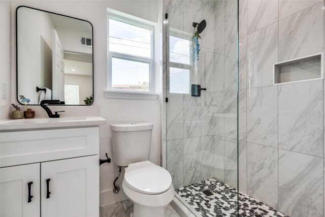 1200 E 52nd St Unit 105, Austin, TX 78723 - bathroom featuring a marble finish shower, toilet, vanity, and marble finish flooring