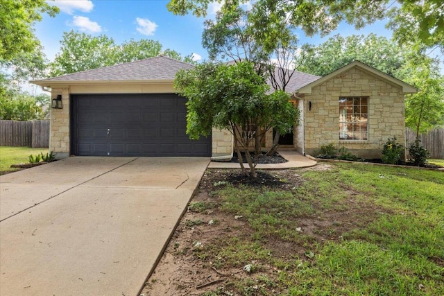 404 N Belinda Ct, Bastrop, TX 78602 - ranch-style house featuring concrete driveway, stone siding, an attached garage, and a shingled roof