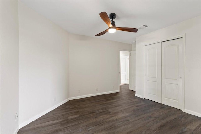 404 N Belinda Ct, Bastrop, TX 78602 - unfurnished bedroom with dark wood finished floors, a closet, baseboards, and a ceiling fan