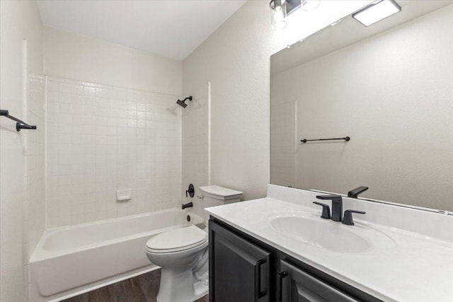 404 N Belinda Ct, Bastrop, TX 78602 - full bath featuring vanity, wood finished floors, toilet, and shower / washtub combination