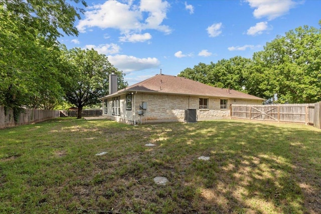 404 N Belinda Ct, Bastrop, TX 78602 - rear view of property featuring a chimney, stone siding, and cooling unit