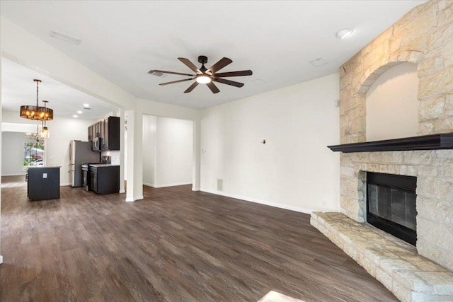 404 N Belinda Ct, Bastrop, TX 78602 - unfurnished living room with ceiling fan, dark wood-type flooring, a fireplace, and baseboards