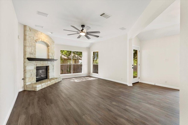 404 N Belinda Ct, Bastrop, TX 78602 - unfurnished living room with dark wood finished floors, ceiling fan, baseboards, and a stone fireplace