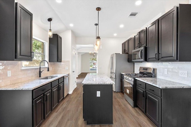 404 N Belinda Ct, Bastrop, TX 78602 - kitchen featuring appliances with stainless steel finishes, a sink, a center island, wood finished floors, and recessed lighting