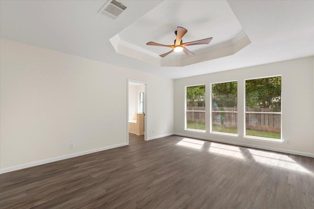 404 N Belinda Ct, Bastrop, TX 78602 - empty room with a raised ceiling, dark wood-style flooring, baseboards, a ceiling fan, and ornamental molding