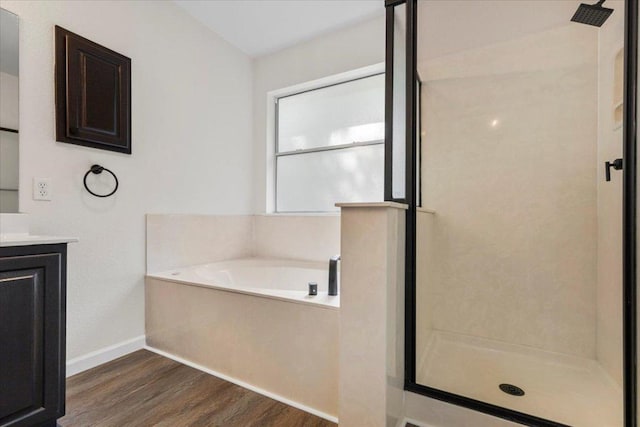 404 N Belinda Ct, Bastrop, TX 78602 - full bath featuring wood finished floors, a stall shower, a bath, and vanity