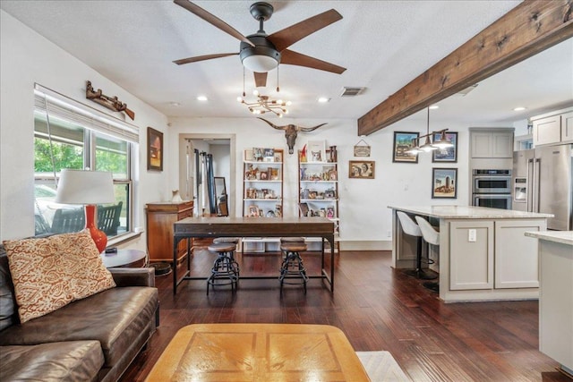 5701 Ave G, Austin, TX 78752 - living room featuring ceiling fan, dark wood-style flooring, recessed lighting, beamed ceiling, and a desk