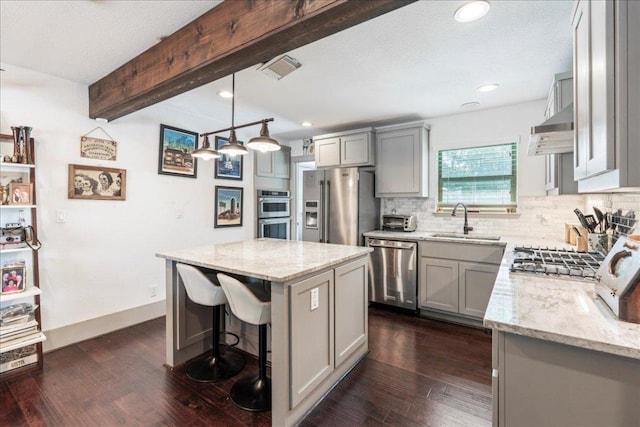 5701 Ave G, Austin, TX 78752 - kitchen with appliances with stainless steel finishes, gray cabinets, light stone counters, beamed ceiling, and recessed lighting